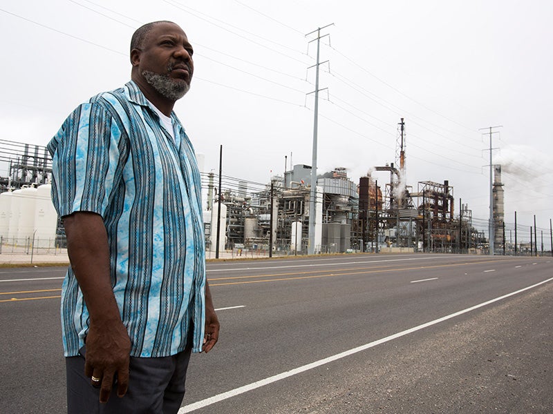 Hilton Kelley, Clean Air Ambassador and Goldman Prize winner, stands near an oil refinery in Port Arthur, TX.