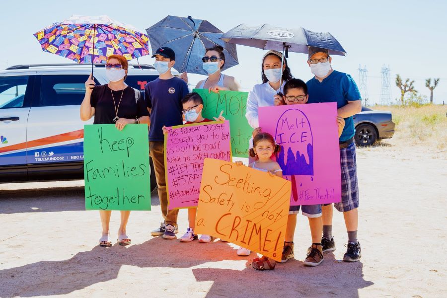 A family gathers at a recent #FreeThemAll protest outside the Adelanto Detention facility.
(Julio Manzo, provided by Inland Empire Coalition for Immigrant Justice)