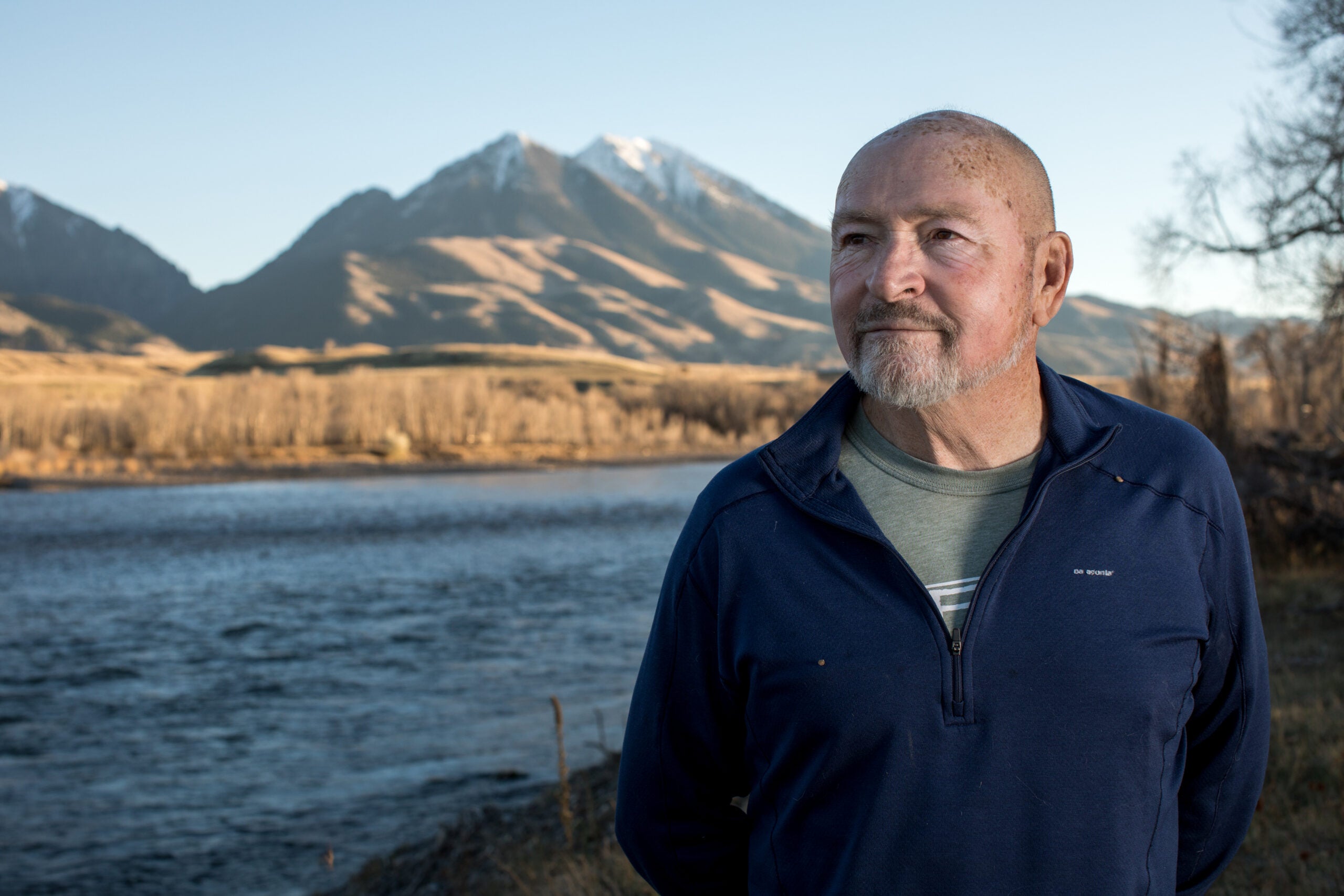 Doug Peacock stands on the edge of the Yellowstone River in Emigrant, Montana.