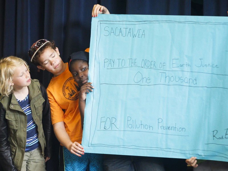 Students at Sacajawea Elementary present a giant, homemade check to Earthjustice for pollution prevention.