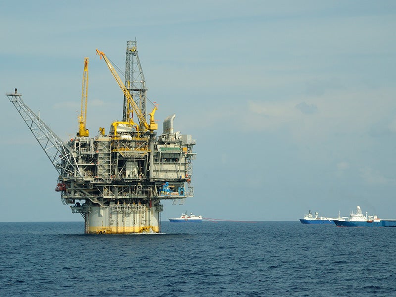 A seismic survey fleet passes an off-shore oil rig in the Gulf of Mexico.