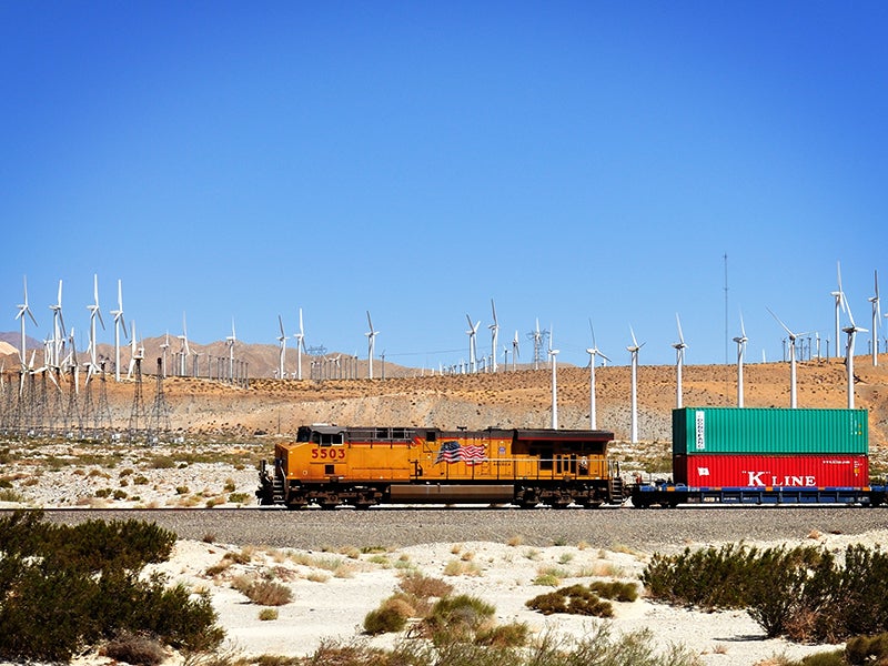 A cargo train passes the windmills outside of Palm Springs, Calif. The state asserts its commitment to a strong economy and a healthy environment in its new Sustainable Freight Action Plan, but it can do even more to clean up the polluting freight system.
(Hit1912/Shutterstock)