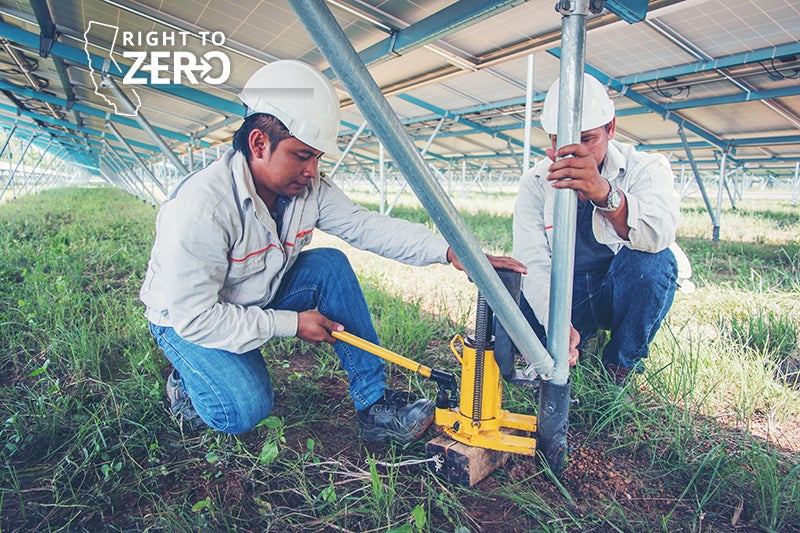 Two engineers check and maintain equipment at a solar power plant. New research shows that many clean energy jobs are a boon for workers from underrepresented communities.