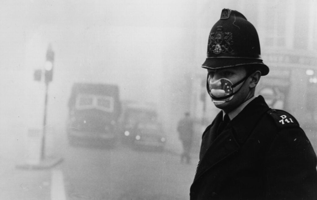 A London police officer wears a mask for protection against the thick fog which hit most of the country and turned to smog in the city, 1952.