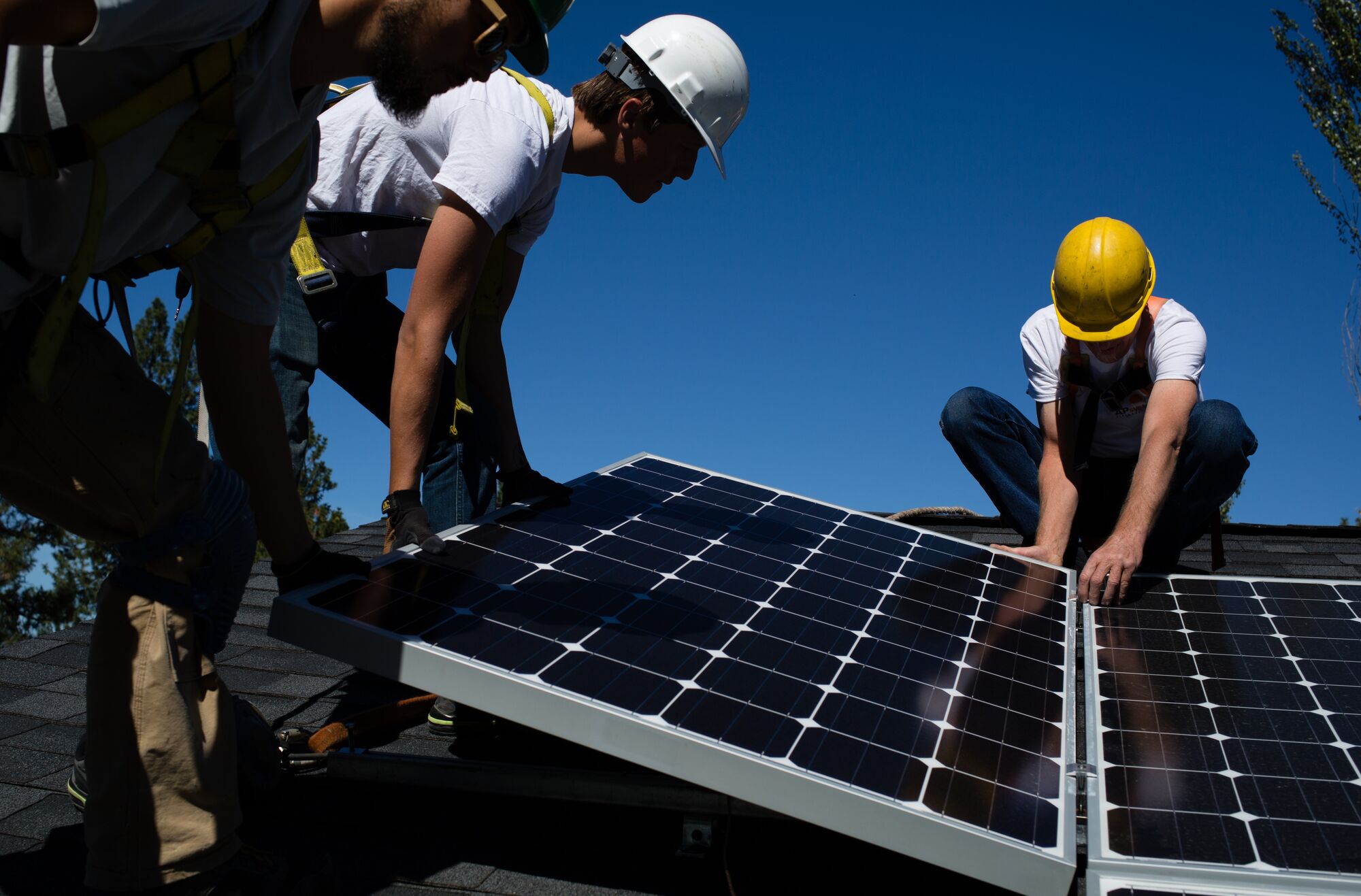 Technicians install rooftop solar panels in Spokane, Washington, in September, 2016. Energy efficiency and renewable energy sources have made the power generated by the Lower Snake River dams unnecessary.