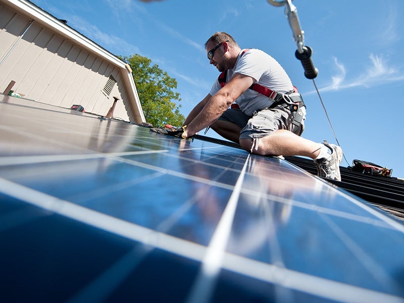 REC Solar employee Brian Webster installs PV modules on a Englewood, Colorado home participating in the Solar Benefits Colorado program
(Dennis Schroeder / NREL)