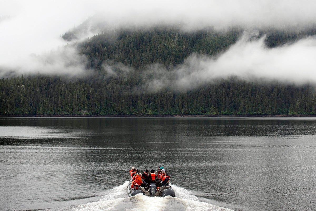 Cruise passengers sit in an inflatable boat offshore from the Tongass near Juneau.