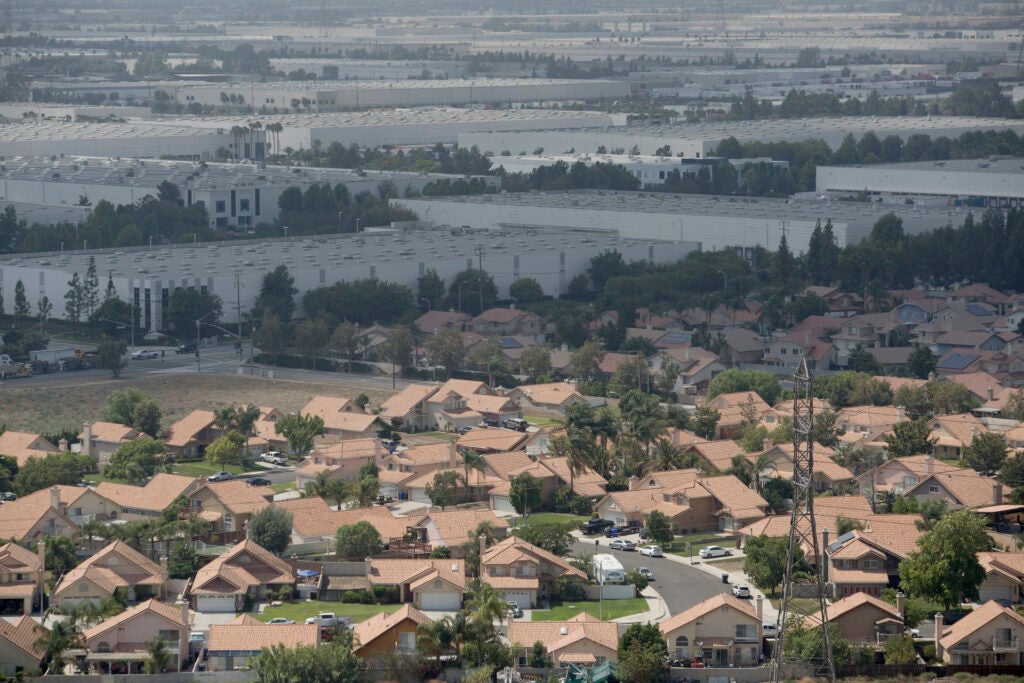 Vast warehouses bump up against homes in Southern California. (David McNew / The New York Times)