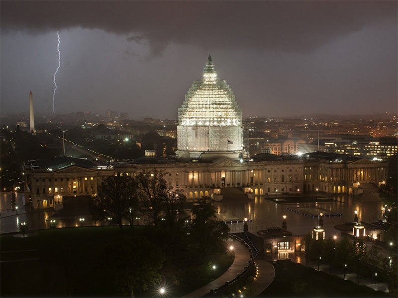Lightning strikes behind the U.S. Capitol.