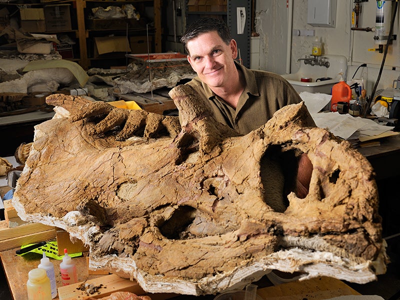 Paleontologist Scott Sampson poses with his favorite dinosaur, the 15-horned Kosmoceratops richardsoni, which was discovered in Grand Staircase National Monument.
(Photo Courtesy Natural History Museum of Utah)