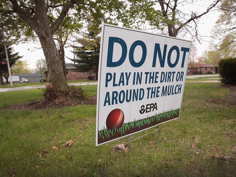 A sign, placed by the EPA, warns people not to play on the lawn at the West Calumet Housing Complex on April 19, 2017, in East Chicago, Indiana. Nearly all the residents of the complex were ordered to move by the East Chicago Housing Authority after the soil and many homes were found to contain high levels of lead. The area has been declared an EPA Superfund site.
(Scott Olson / Getty Images)