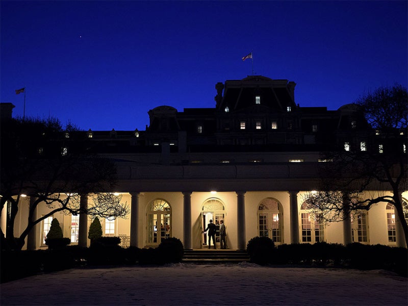 President Obama enters the Oval Office at dusk.