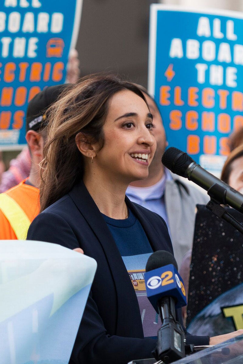 Yasmine Agelidis, senior associate attorney with Earthjustice's California Regional Office, speaks at a rally for electric school buses outside the LA Unified School District headquarters.