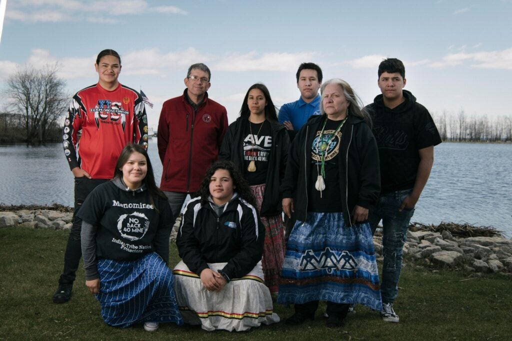 Menominee youth gather at the mouth of the Menominee River with Tribal Chairman Douglas Cox and high school teacher Dawn Wilber.
(Kiliii Yuyan for Earthjustice)